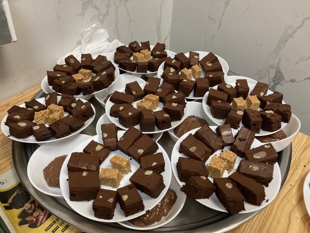 8 borden vol met brownies staan te wachten totdat het tijd is voor het toetje.